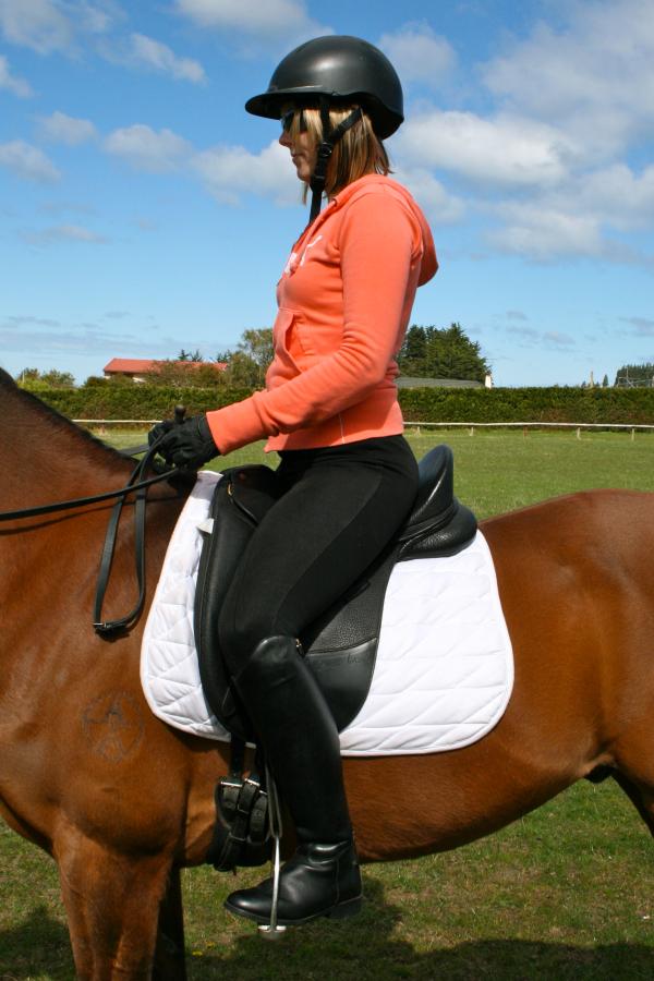 Lumbar Lordosis - excessive curvature of the lower back, note the rider’s ribs stick out in front & her shoulders sit back from her hips.